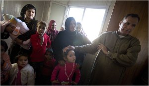 Ahmed Hassan Sharmal, right, and his extended family of 30, including three war widows, are forced to share only two trailers. (Johan Spanner for The New York Times)